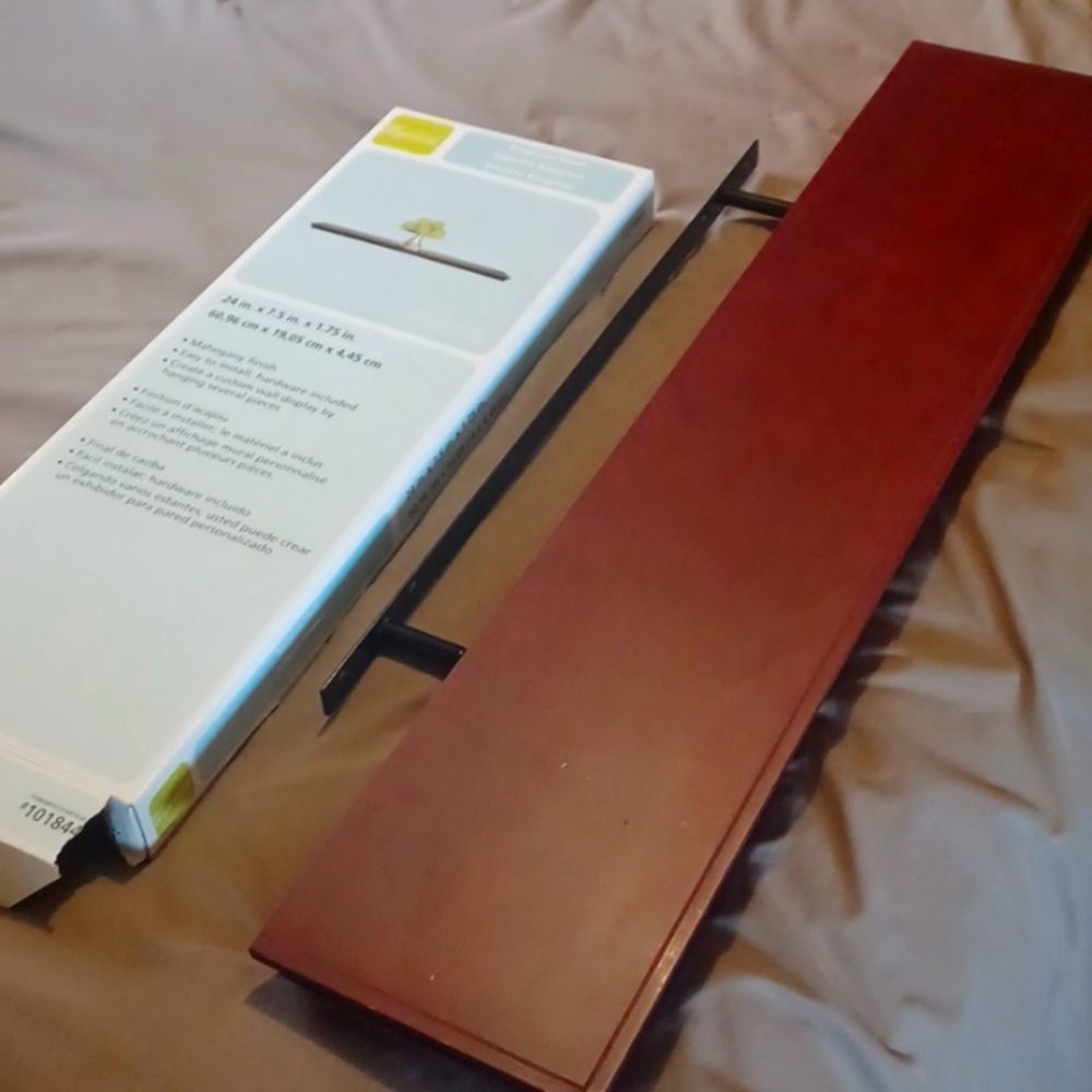 2 floating mahogany colored shelves